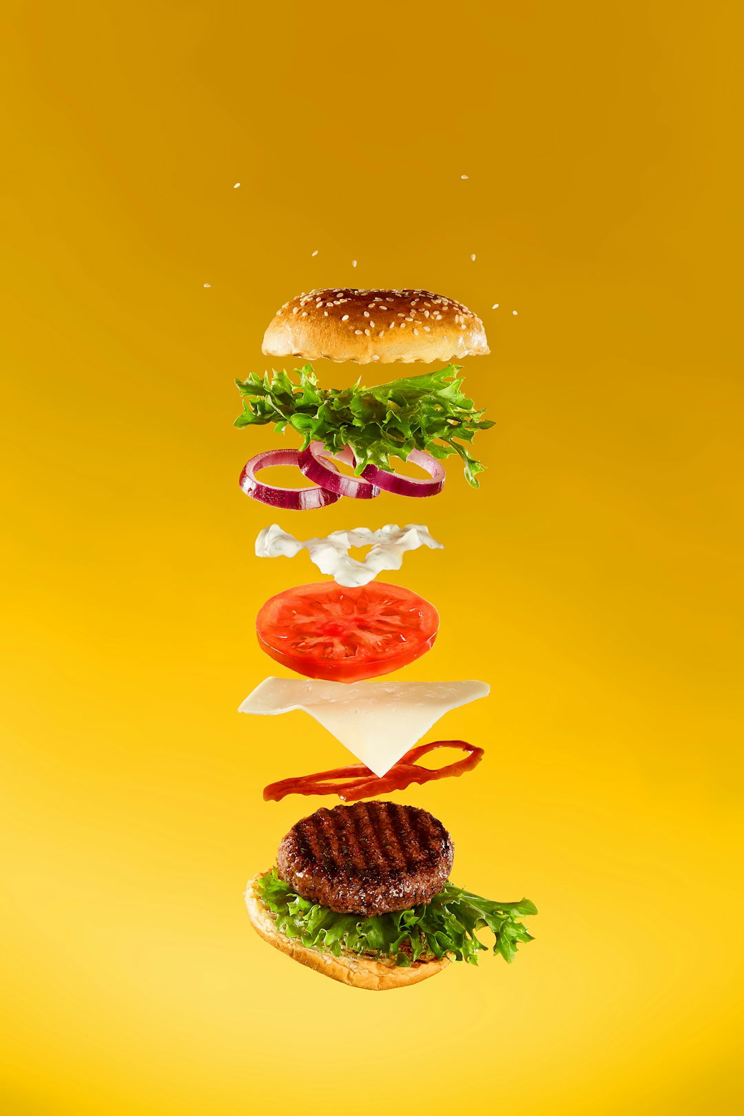 a-hamburger-flying-through-the-air-with-a-lot-of-toppings-on-it.jpg a hamburger flying through the air with a lot of toppings on it